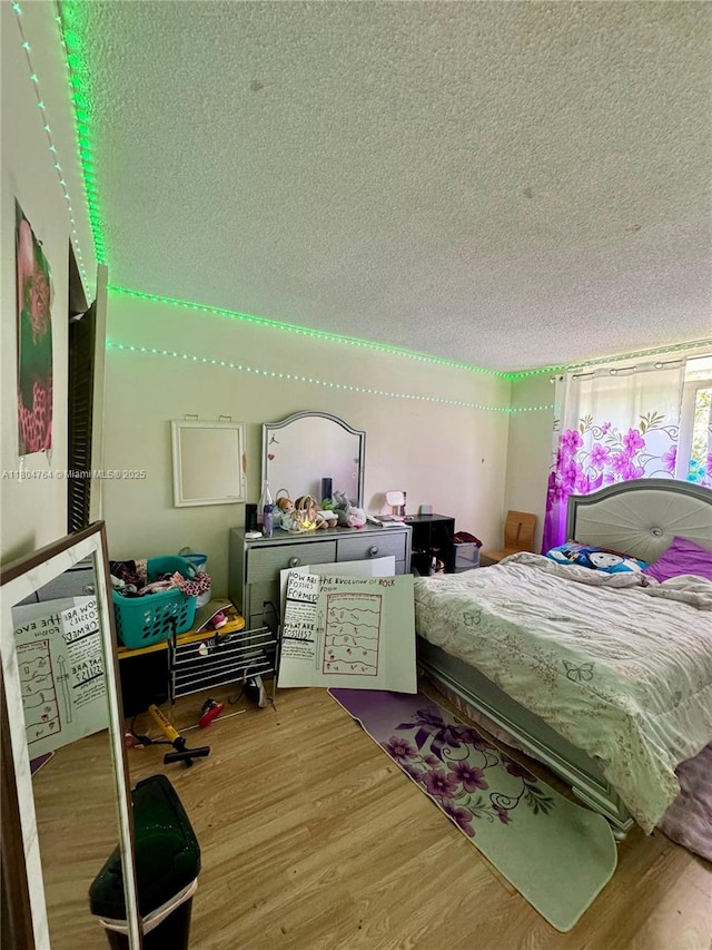 3660 Inverrary Dr Unit 2W, Lauderhill, FL 33319 - bedroom with a textured ceiling and wood finished floors
