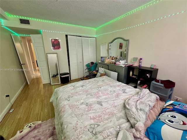 3660 Inverrary Dr Unit 2W, Lauderhill, FL 33319 - bedroom featuring a textured ceiling, a closet, wood finished floors, and baseboards