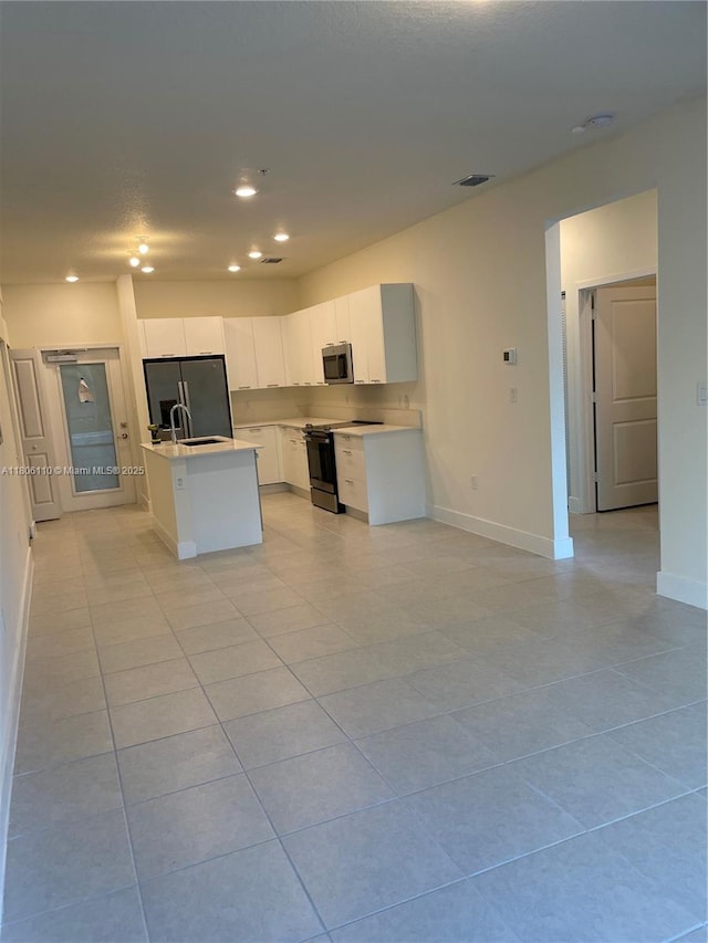 8001NW 41st St Unit F-108, Doral, FL 33166 - kitchen featuring black range, stainless steel microwave, light countertops, light tile patterned floors, and recessed lighting