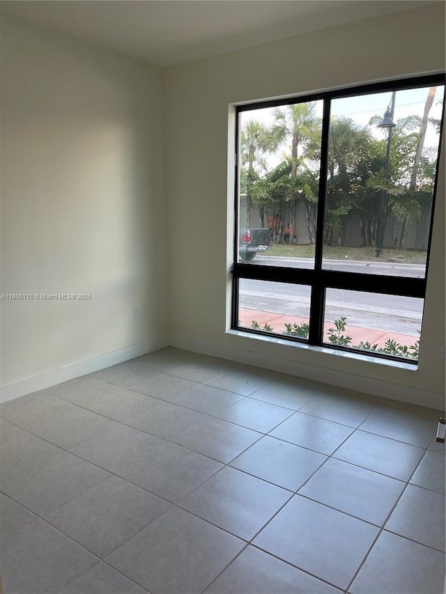 8001NW 41st St Unit F-108, Doral, FL 33166 - tiled empty room featuring baseboards
