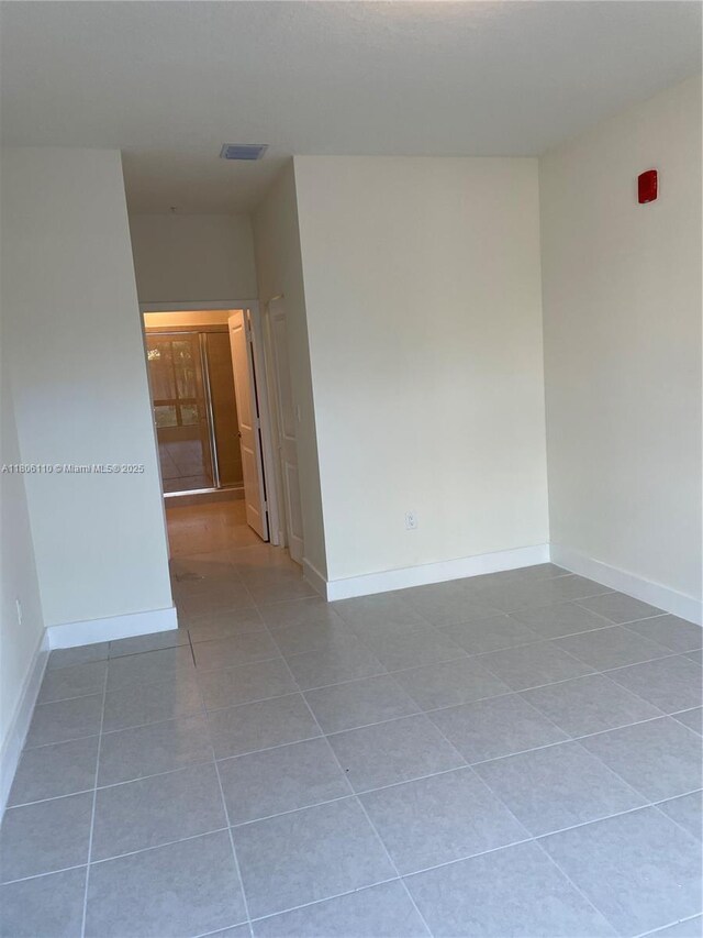8001NW 41st St Unit F-108, Doral, FL 33166 - tiled spare room featuring baseboards