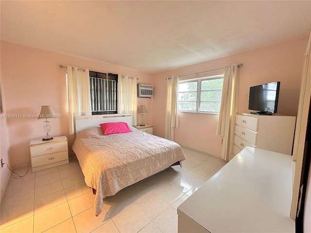 bedroom featuring an AC wall unit and light tile patterned flooring