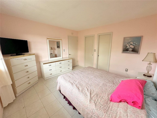 bedroom with light tile patterned flooring