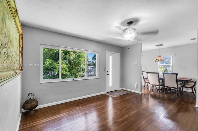foyer featuring wood finished floors, a ceiling fan, and baseboards