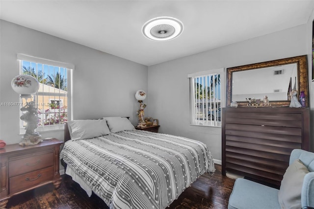 bedroom featuring wood finished floors and baseboards