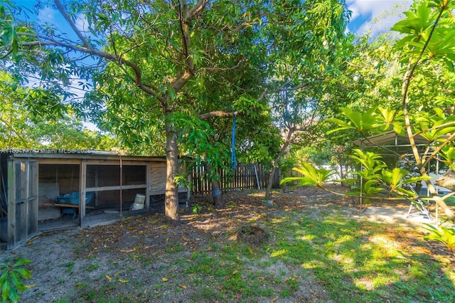 view of yard featuring fence and an outbuilding