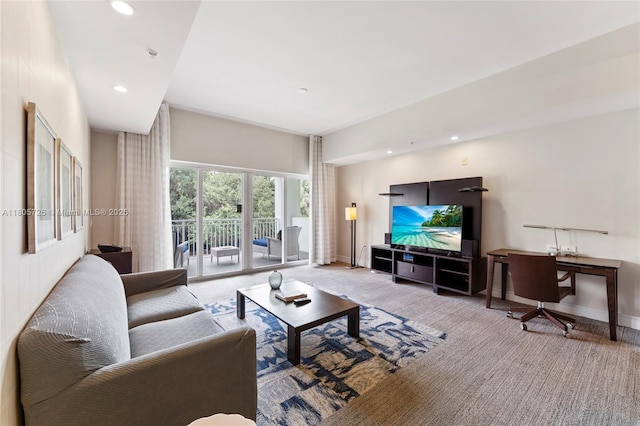 carpeted living area featuring recessed lighting and baseboards