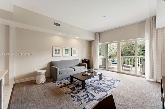 living room with light colored carpet, baseboards, and recessed lighting
