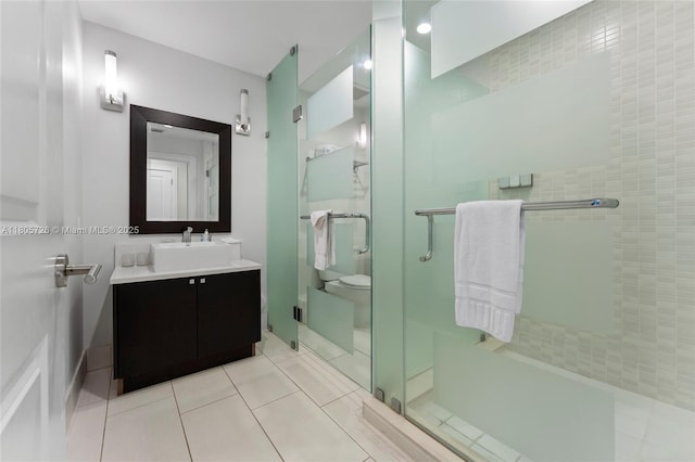 full bathroom with a stall shower, vanity, and tile patterned flooring