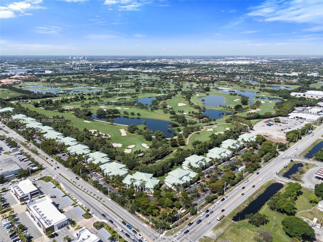 aerial view of property's location with a nearby body of water and a golf club
