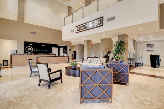 community lobby with a high ceiling, stairway, and recessed lighting