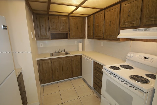 2450 NE 135th St Unit 805, North Miami, FL 33181 - kitchen with white appliances, a sink, under cabinet range hood, light countertops, and light tile patterned flooring