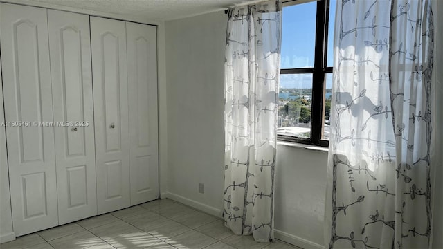 2450 NE 135th St Unit 805, North Miami, FL 33181 - bathroom with baseboards, a textured ceiling, and tile patterned flooring