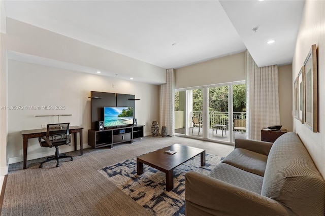 carpeted living area with recessed lighting and baseboards