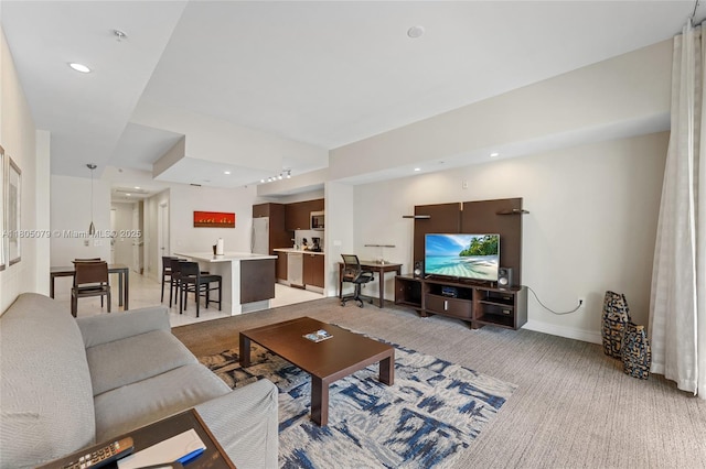 living area with light carpet, recessed lighting, and baseboards