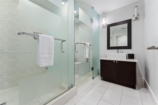 full bathroom with a shower stall, vanity, and tile patterned floors