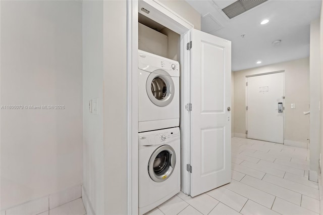 washroom featuring stacked washer and clothes dryer, light tile patterned flooring, baseboards, and recessed lighting