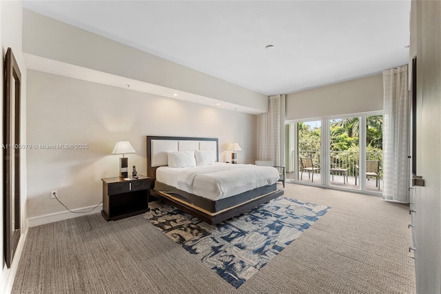 carpeted bedroom with access to exterior and baseboards