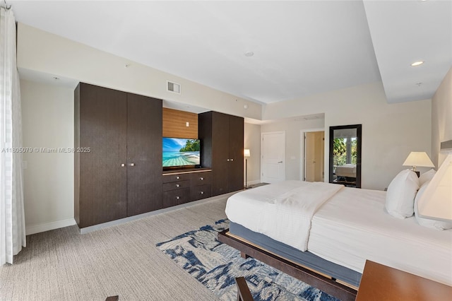 bedroom with light carpet and baseboards