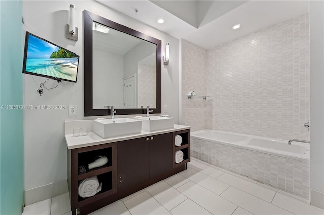 bathroom featuring tiled tub, tile patterned floors, double vanity, and recessed lighting