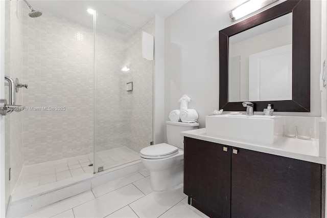 full bathroom featuring a shower stall, tile patterned flooring, toilet, and vanity