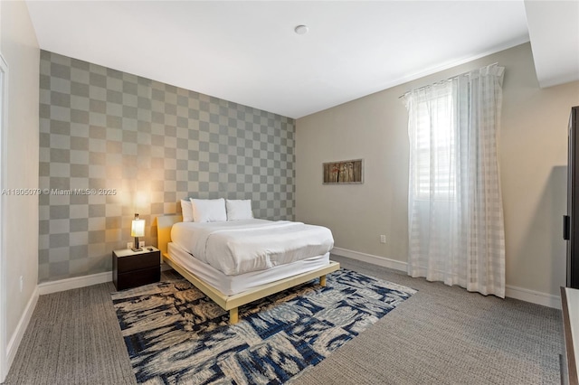 carpeted bedroom with an accent wall, baseboards, and wallpapered walls