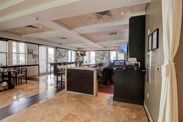 home office with baseboards, plenty of natural light, and a drop ceiling