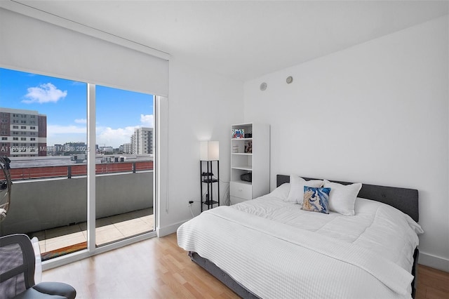350 NE 24th St Unit 714, Miami, FL 33137 - bedroom featuring a view of city, wood finished floors, and baseboards