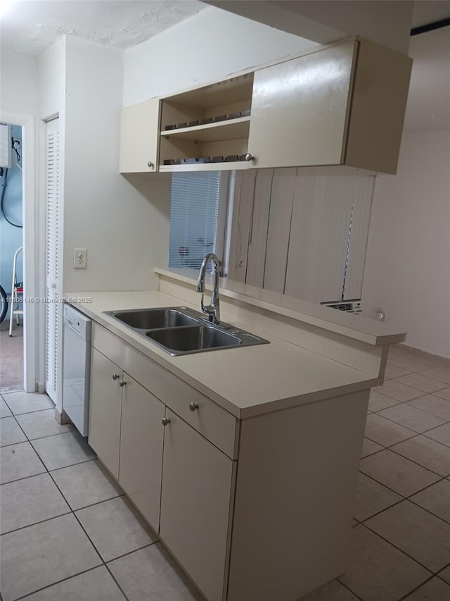 2700 NE 135th St Unit 30, North Miami, FL 33181 - kitchen featuring a sink, dishwasher, light tile patterned floors, and light countertops