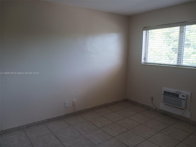 2700 NE 135th St Unit 30, North Miami, FL 33181 - spare room featuring light tile patterned floors, a wall unit AC, and baseboards
