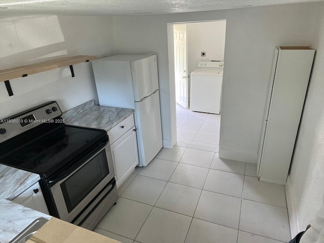 126 NW 13th Ave, Dania Beach, FL 33004 - kitchen featuring washer / clothes dryer, stainless steel electric stove, freestanding refrigerator, light countertops, and light tile patterned floors