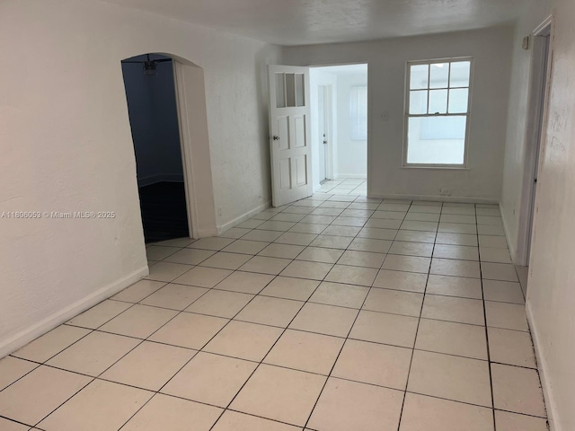 126 NW 13th Ave, Dania Beach, FL 33004 - spare room with arched walkways and light tile patterned floors