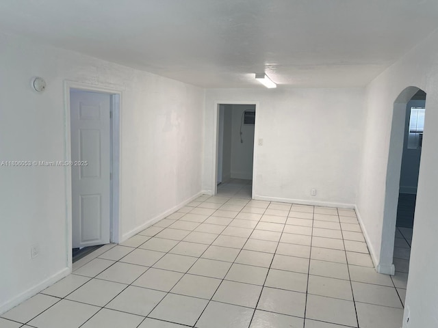 126 NW 13th Ave, Dania Beach, FL 33004 - unfurnished room featuring arched walkways, light tile patterned flooring, a smoke detector, and baseboards