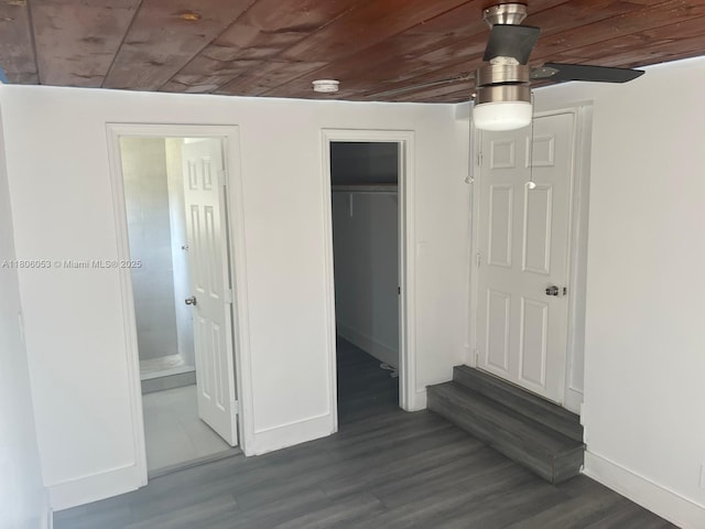 126 NW 13th Ave, Dania Beach, FL 33004 - unfurnished bedroom with wooden ceiling, baseboards, dark wood finished floors, a closet, and connected bathroom
