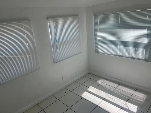 126 NW 13th Ave, Dania Beach, FL 33004 - spare room with baseboards and light tile patterned flooring