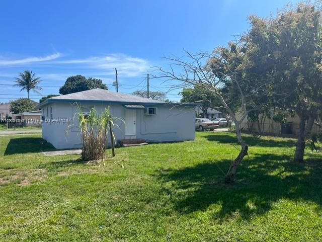 126 NW 13th Ave, Dania Beach, FL 33004 - rear view of house featuring a lawn