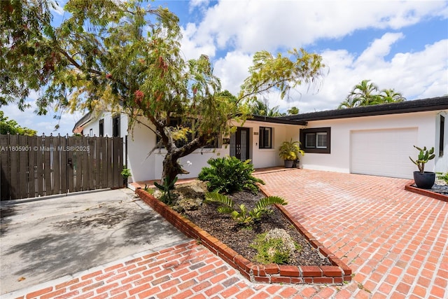 5020 SW 82nd Ave, Miami, FL 33155 - ranch-style home with stucco siding, decorative driveway, and an attached garage