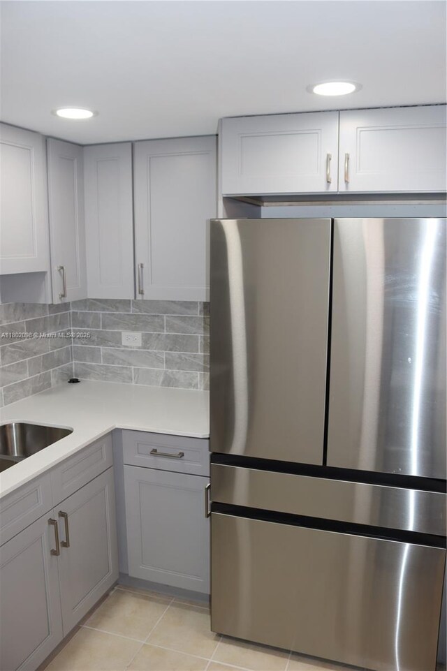 3730 Inverrary Dr Unit 2Y, Lauderhill, FL 33319 - kitchen with freestanding refrigerator, gray cabinetry, light countertops, backsplash, and light tile patterned floors