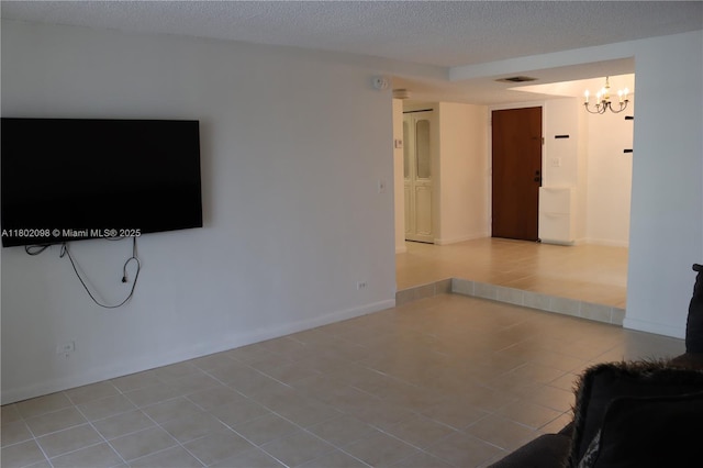 3730 Inverrary Dr Unit 2Y, Lauderhill, FL 33319 - unfurnished living room featuring a chandelier and a textured ceiling
