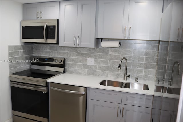 3730 Inverrary Dr Unit 2Y, Lauderhill, FL 33319 - kitchen featuring stainless steel appliances, a sink, light countertops, backsplash, and gray cabinetry