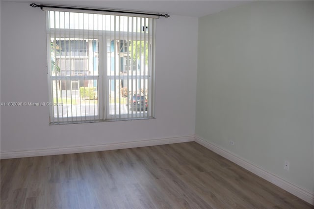 3730 Inverrary Dr Unit 2Y, Lauderhill, FL 33319 - empty room featuring plenty of natural light, wood finished floors, and baseboards