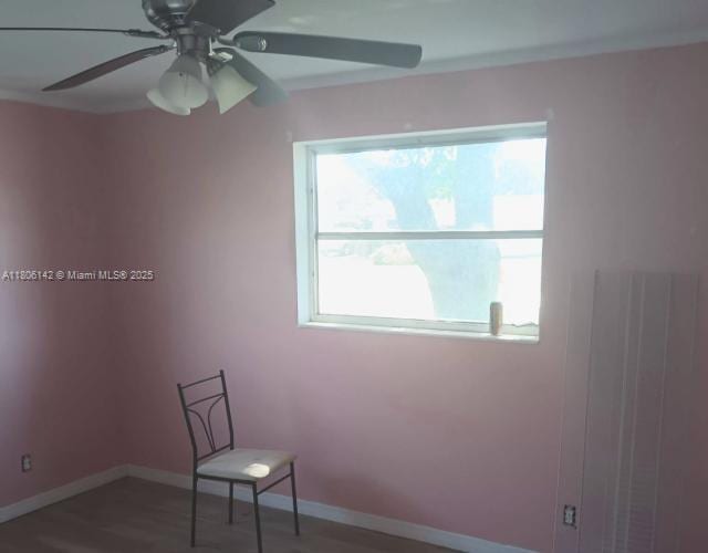 884 Montego Dr, West Palm Beach, FL 33415 - spare room with a ceiling fan, wood finished floors, and baseboards