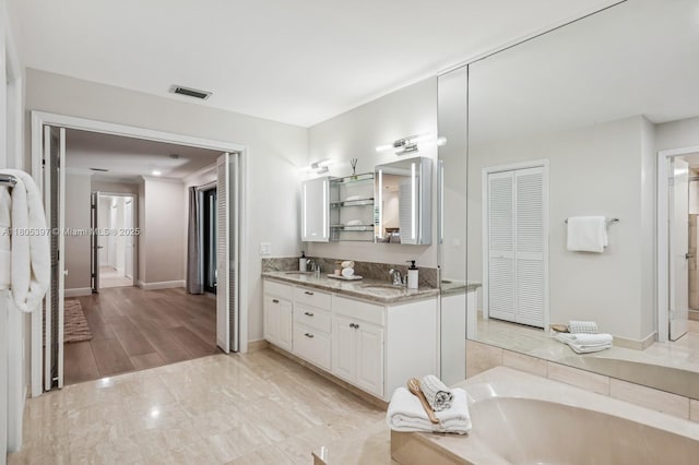 7935 SW 155th St, Palmetto Bay, FL 33157 - full bath featuring double vanity, a garden tub, baseboards, and a closet