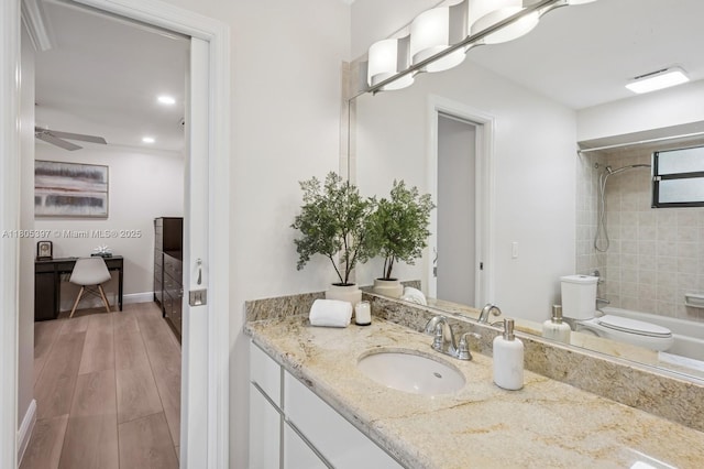 7935 SW 155th St, Palmetto Bay, FL 33157 - bathroom featuring vanity, toilet, bathtub / shower combination, a ceiling fan, and wood finished floors