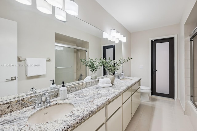 7935 SW 155th St, Palmetto Bay, FL 33157 - bathroom featuring a shower with shower door, toilet, double vanity, and tile patterned flooring