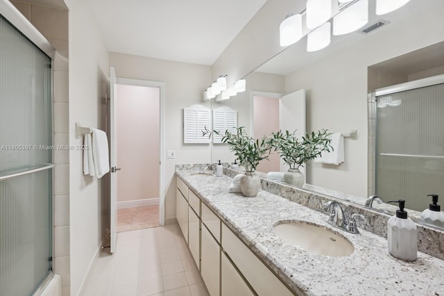 7935 SW 155th St, Palmetto Bay, FL 33157 - bathroom featuring double vanity, a shower with shower door, tile patterned flooring, and baseboards