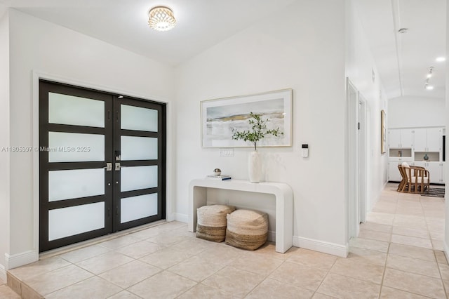 7935 SW 155th St, Palmetto Bay, FL 33157 - entrance foyer with light tile patterned floors, lofted ceiling, baseboards, and french doors