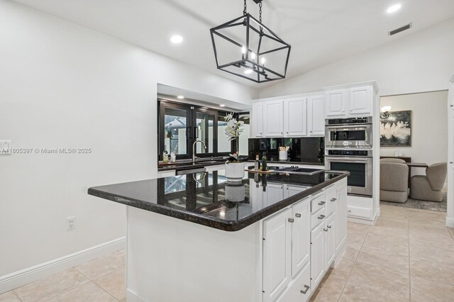 7935 SW 155th St, Palmetto Bay, FL 33157 - kitchen featuring white cabinets, stainless steel double oven, lofted ceiling, recessed lighting, and decorative light fixtures