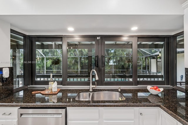 7935 SW 155th St, Palmetto Bay, FL 33157 - kitchen with dishwasher, a sink, dark stone countertops, and healthy amount of natural light