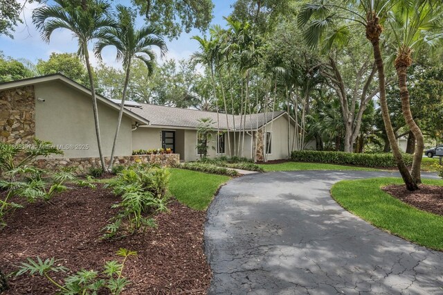 7935 SW 155th St, Palmetto Bay, FL 33157 - mid-century home with stucco siding, curved driveway, and a front lawn